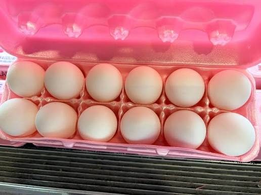 A carton of pink-dyed eggs